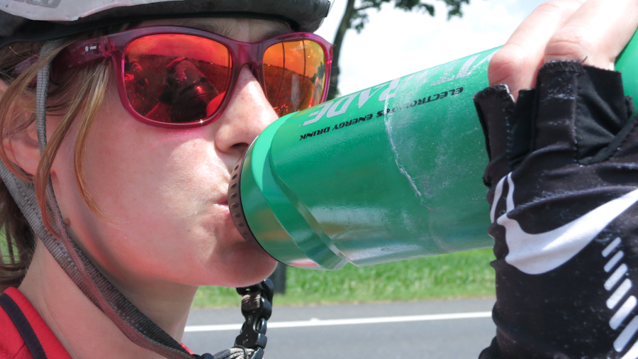 Cyclist rehydrating during a ride